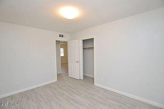 6431 East Sandra Terrace Scottsdale, AZ 85254 - Photo 11 of 19 a view of an empty room and wooden floor