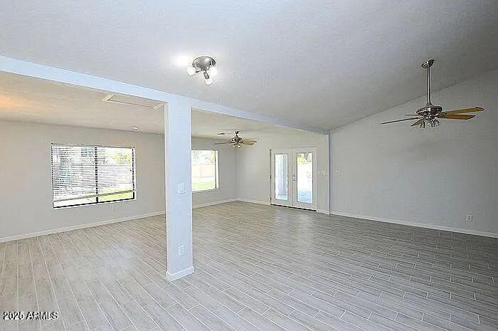 6431 East Sandra Terrace Scottsdale, AZ 85254 - Photo 13 of 19 an empty room with wooden floor and windows