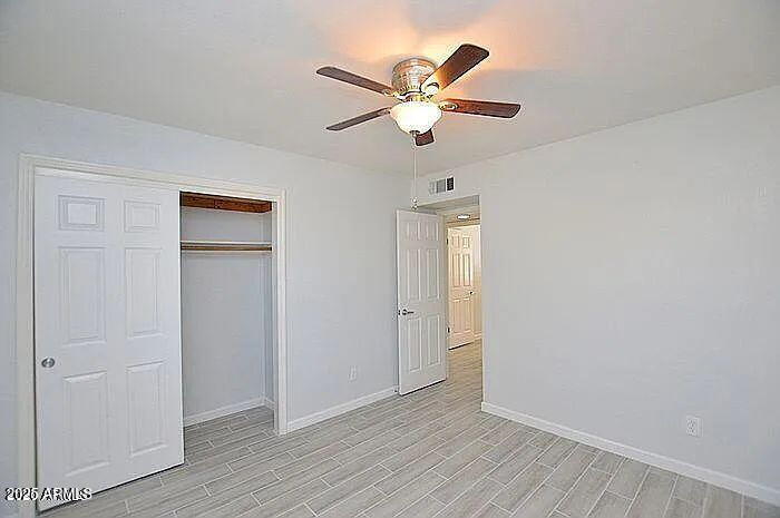 6431 East Sandra Terrace Scottsdale, AZ 85254 - Photo 15 of 19 a view of an empty room with wooden floor