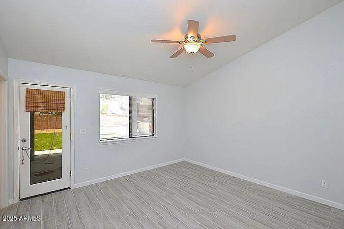 6431 East Sandra Terrace Scottsdale, AZ 85254 - Photo 16 of 19 a view of an empty room with wooden floor and a window
