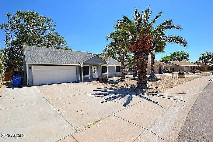 6431 East Sandra Terrace Scottsdale, AZ 85254 - Photo 2 of 19 a house with palm tree in front of it