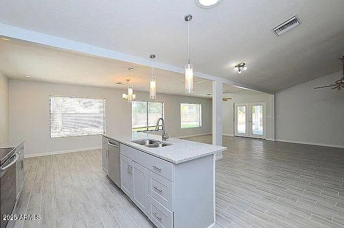 6431 East Sandra Terrace Scottsdale, AZ 85254 - Photo 5 of 19 a kitchen with stainless steel appliances granite countertop a sink stove and wooden floor
