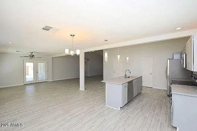 a open kitchen with cabinets stove and wooden floor
