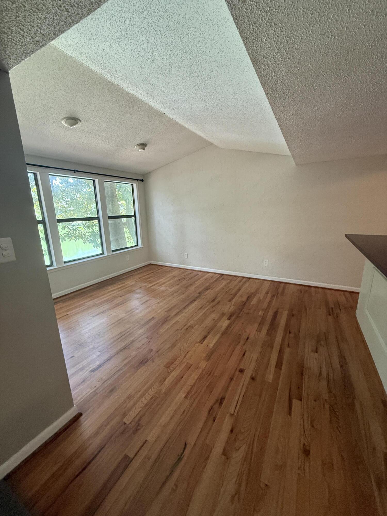 504 Main Street Destin, FL 32541 - Photo 13 of 25 wooden floor in an empty room with a window