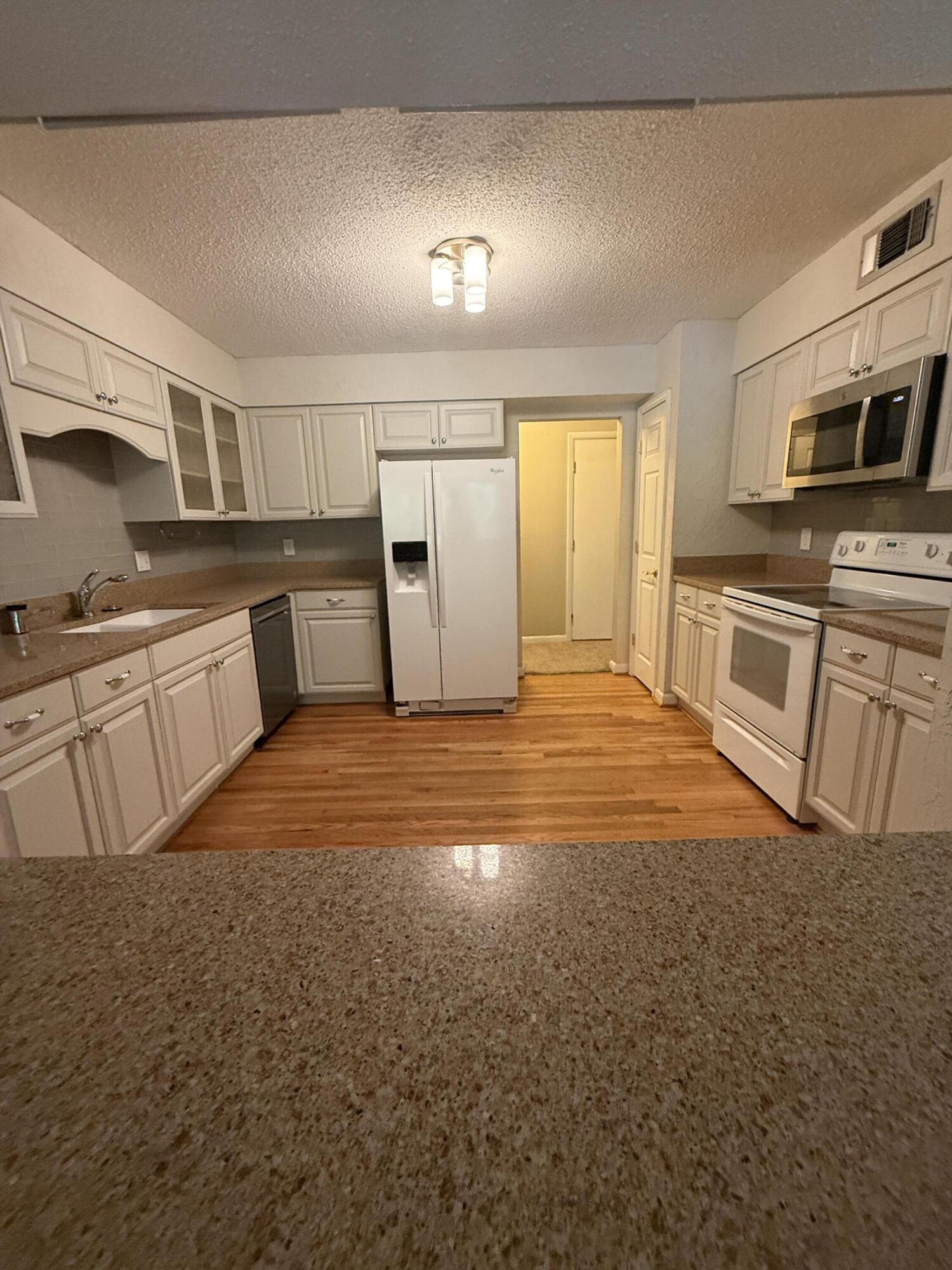 504 Main Street Destin, FL 32541 - Photo 14 of 25 a large kitchen with cabinets and stainless steel appliances