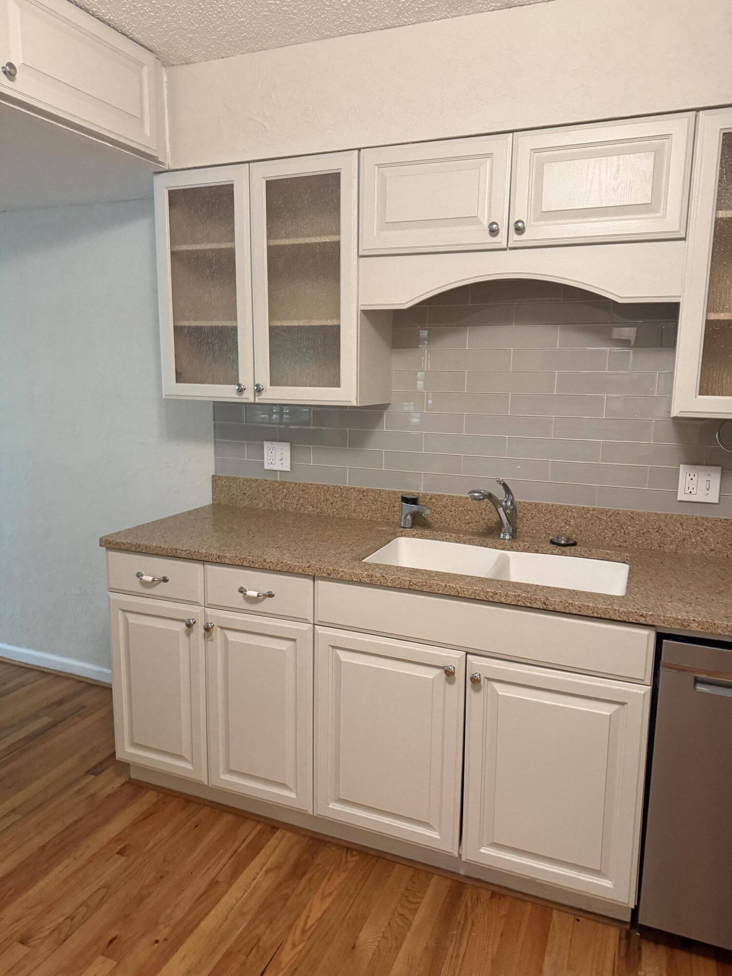 504 Main Street Destin, FL 32541 - Photo 17 of 25 a kitchen with granite countertop white cabinets and a sink