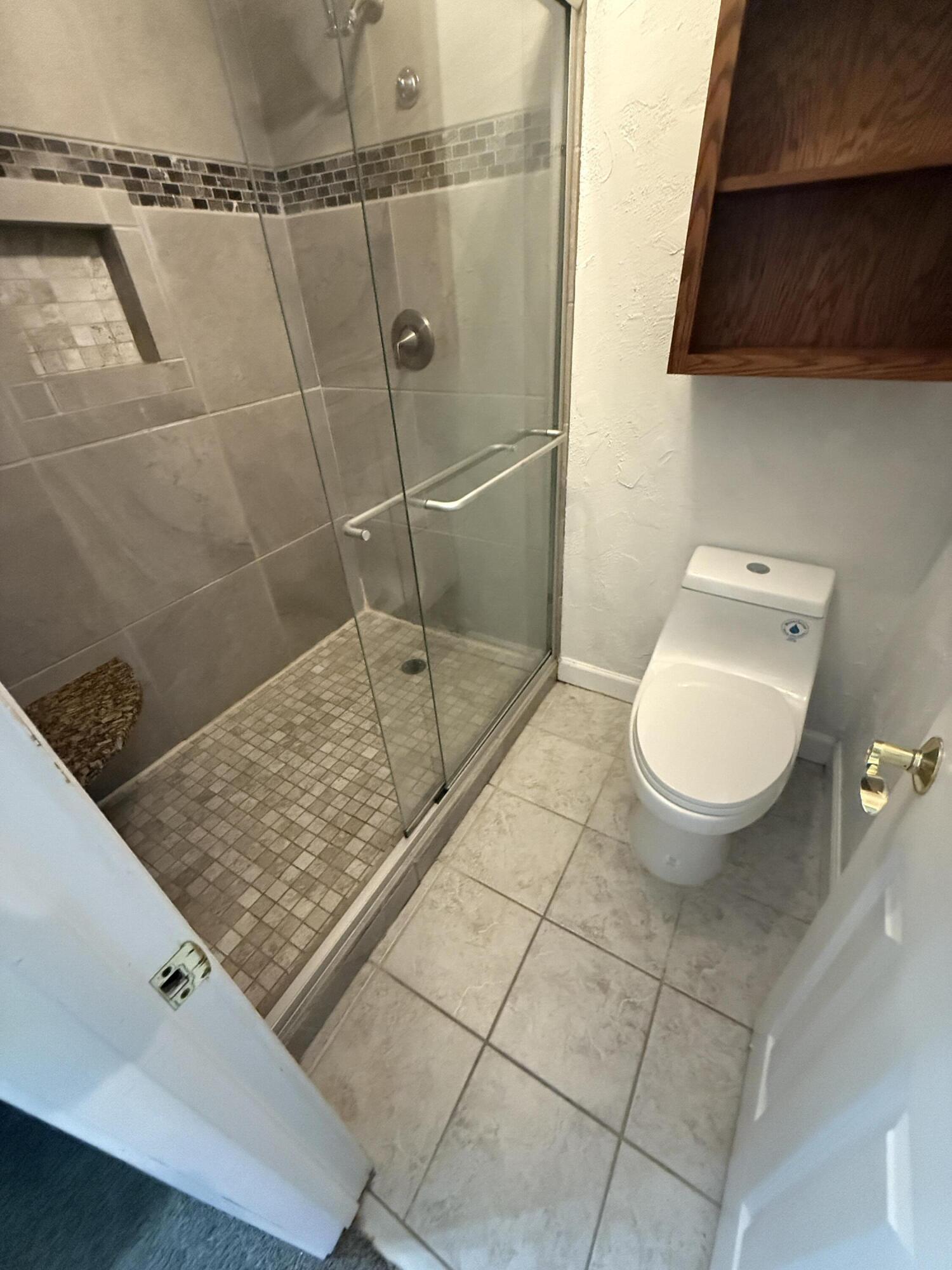 504 Main Street Destin, FL 32541 - Photo 19 of 25 a bathroom with a sink a toilet and a mirror