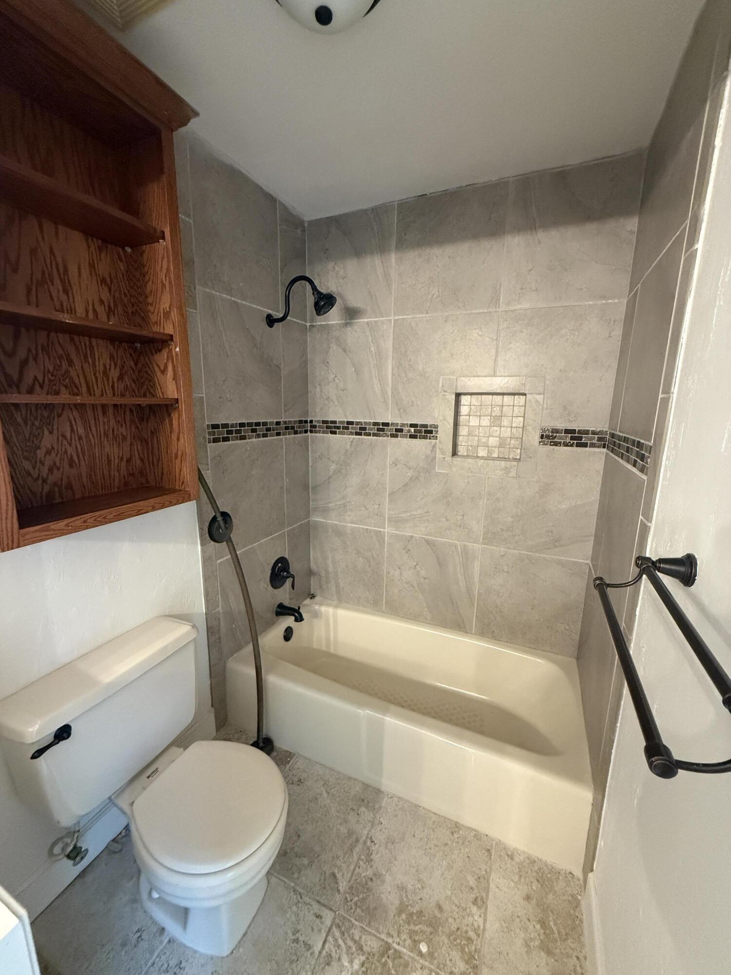 504 Main Street Destin, FL 32541 - Photo 25 of 25 a bathroom with a toilet and a bath tub