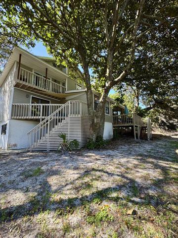 504 Main Street Destin, FL 32541 - Photo 3 of 25 a view of a big house with a tree in front of it