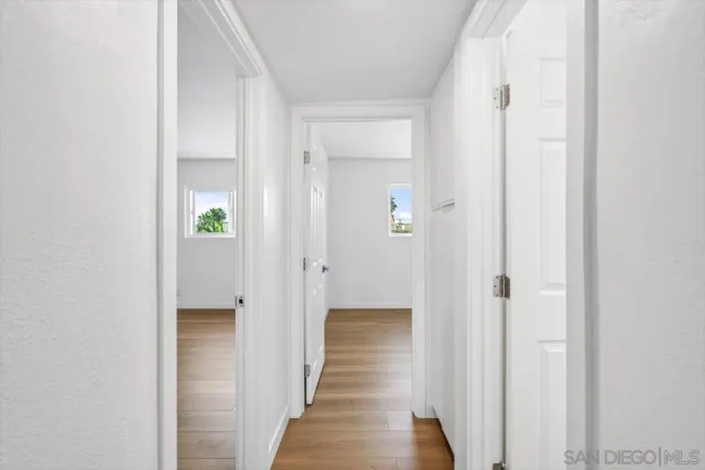 a view of a hallway with wooden floor