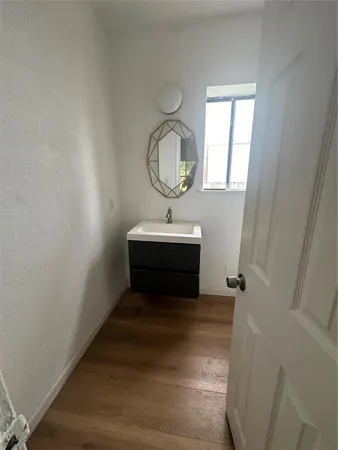 a bathroom with a sink toilet and a mirror