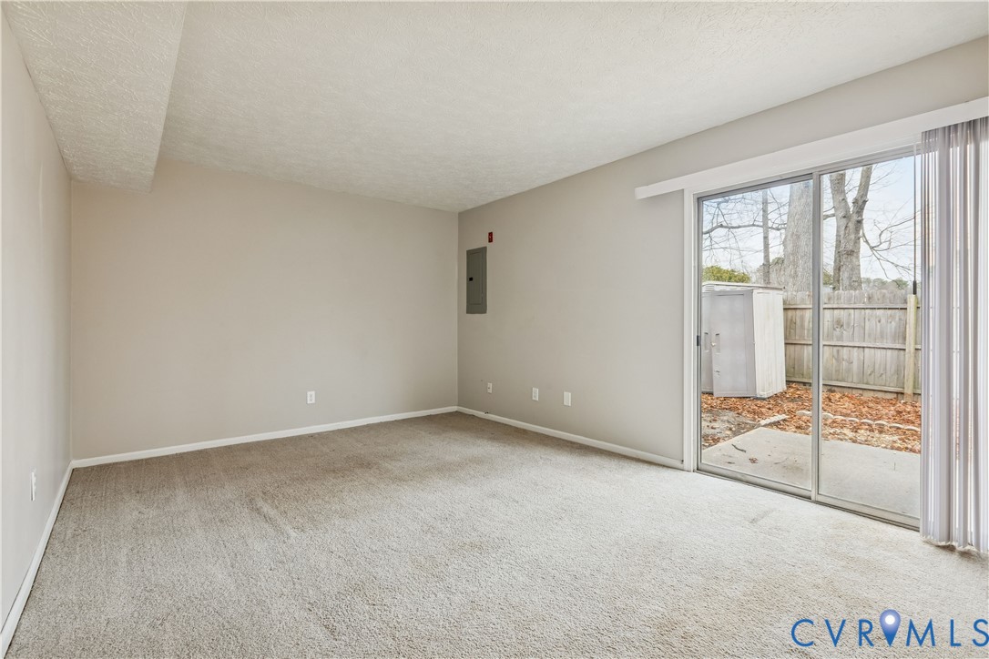 377 Kinsmen Way Hampton, VA 23666 - Photo 14 of 30 an empty room with sliding glass door and shower