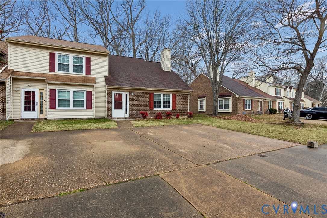 377 Kinsmen Way Hampton, VA 23666 - Photo 2 of 30 a front view of a house with a garden