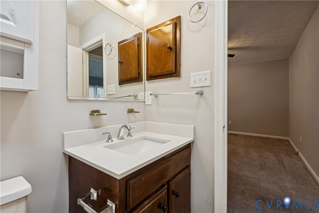 377 Kinsmen Way Hampton, VA 23666 - Photo 21 of 30 a bathroom with a sink and a mirror