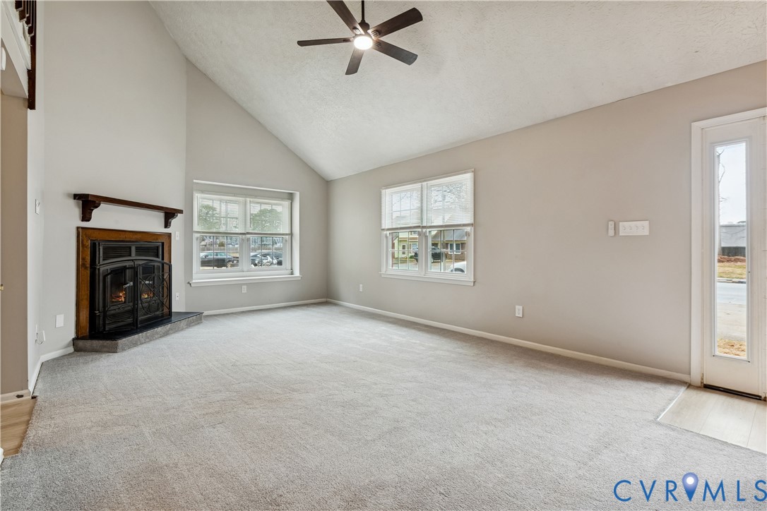 377 Kinsmen Way Hampton, VA 23666 - Photo 7 of 30 an empty room with windows fireplace and fan