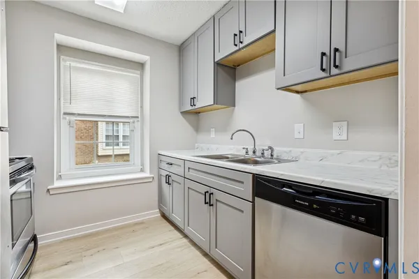 a kitchen with appliances cabinets and a window