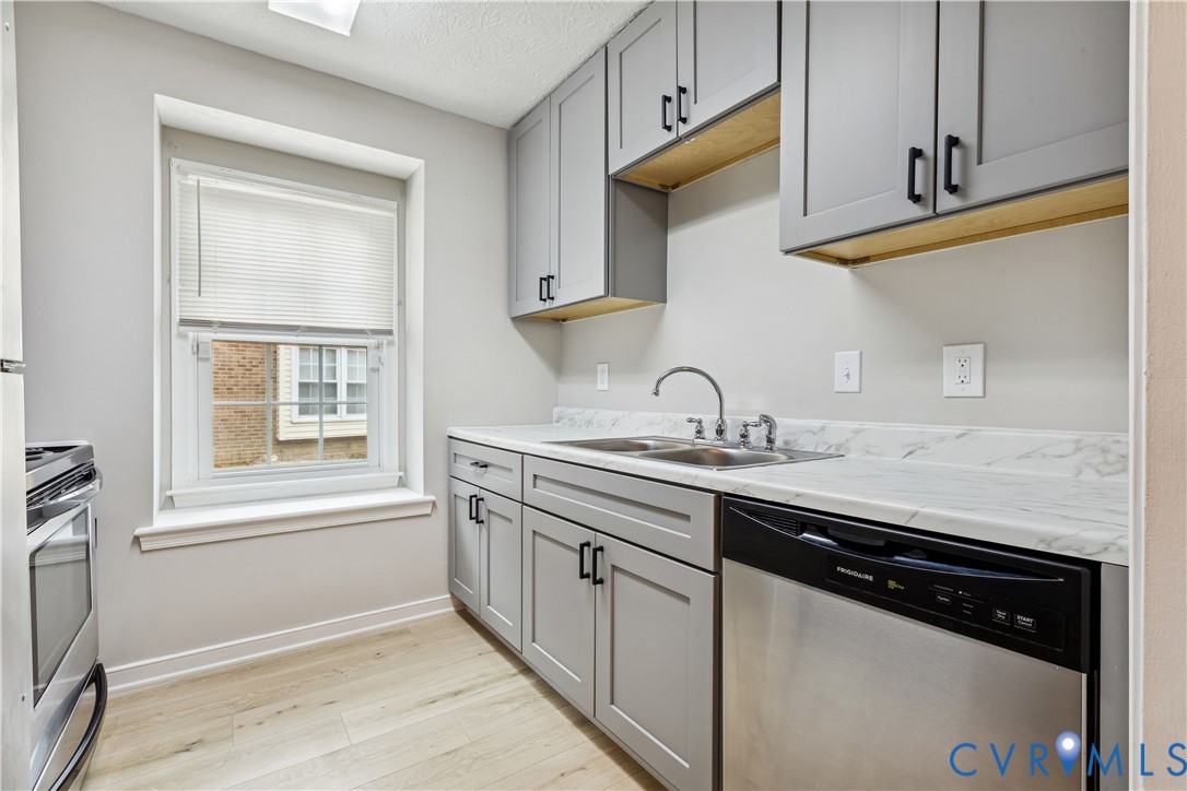 377 Kinsmen Way Hampton, VA 23666 - Photo 9 of 30 a kitchen with stainless steel appliances granite countertop a sink stove and cabinets
