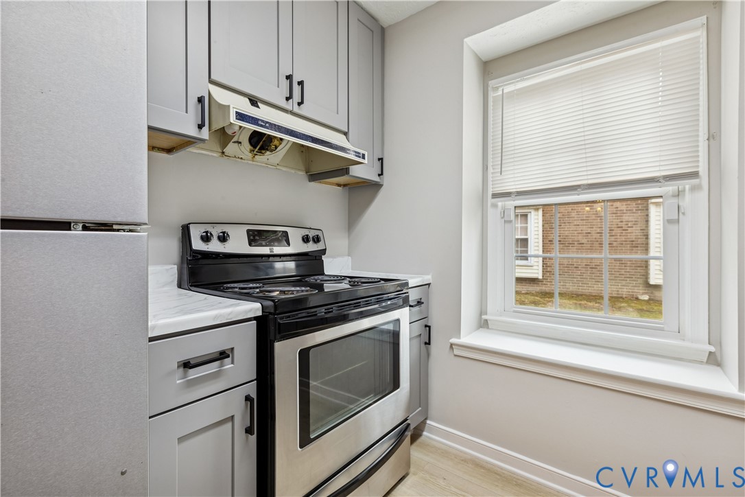 377 Kinsmen Way Hampton, VA 23666 - Photo 10 of 30 a kitchen with appliances cabinets and a window