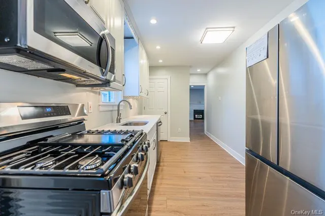 a kitchen with stainless steel appliances granite countertop a stove and a refrigerator