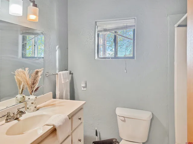 a bathroom with a toilet sink and mirror