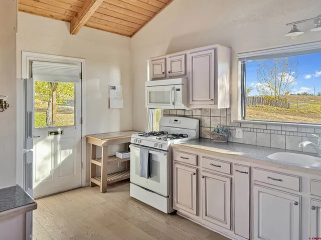 a kitchen with stainless steel appliances granite countertop a stove and a sink