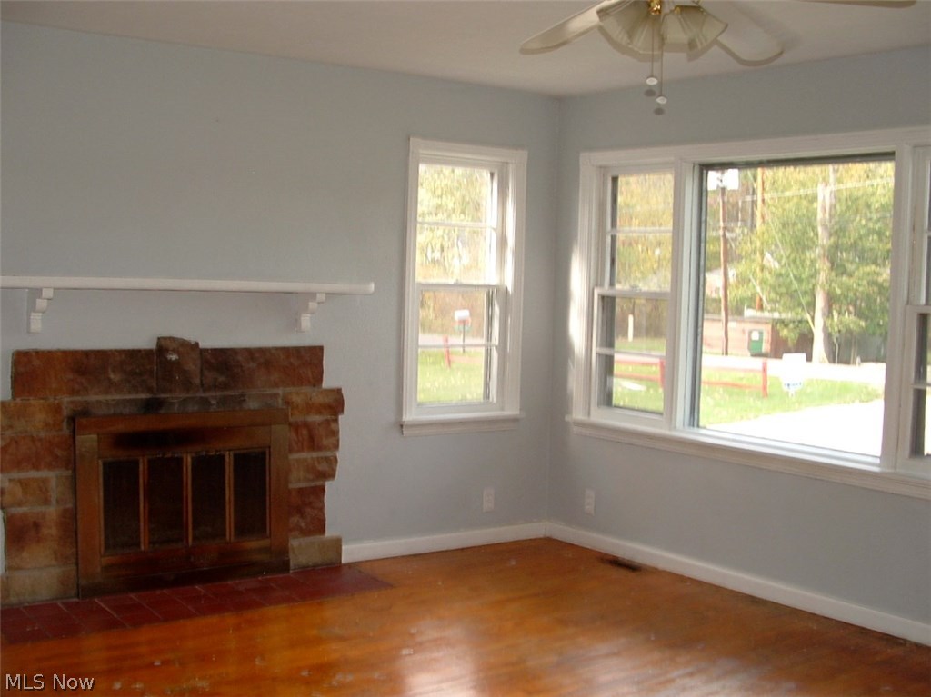 Great room contains a triple window on the front wall of home and an additional side window. Perfect for sunny days.