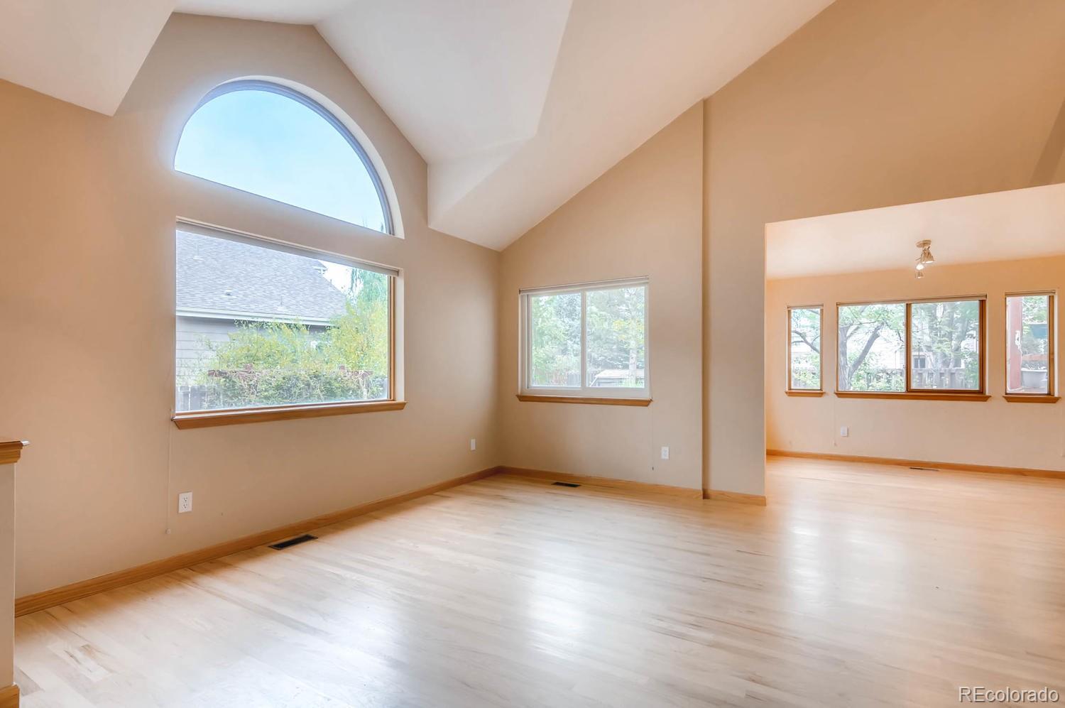 7315 Buckingham Road Boulder, CO 80301 - Photo 8 of 31 an empty room with wooden floor and windows
