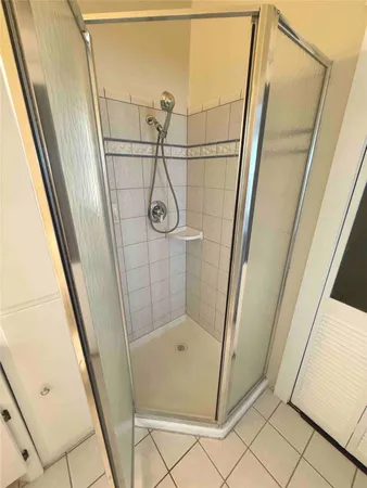 a bathroom with a glass door shower and sink