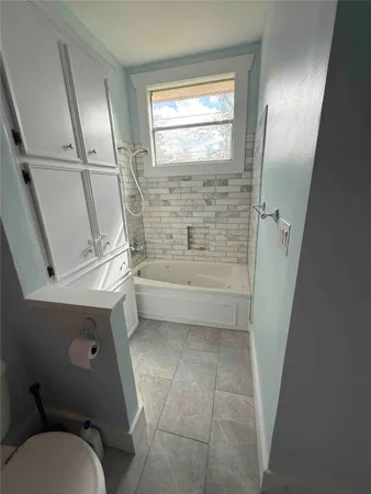 a bathroom with a toilet sink and tub