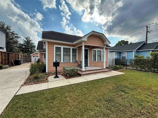 a front view of a house with a yard and porch