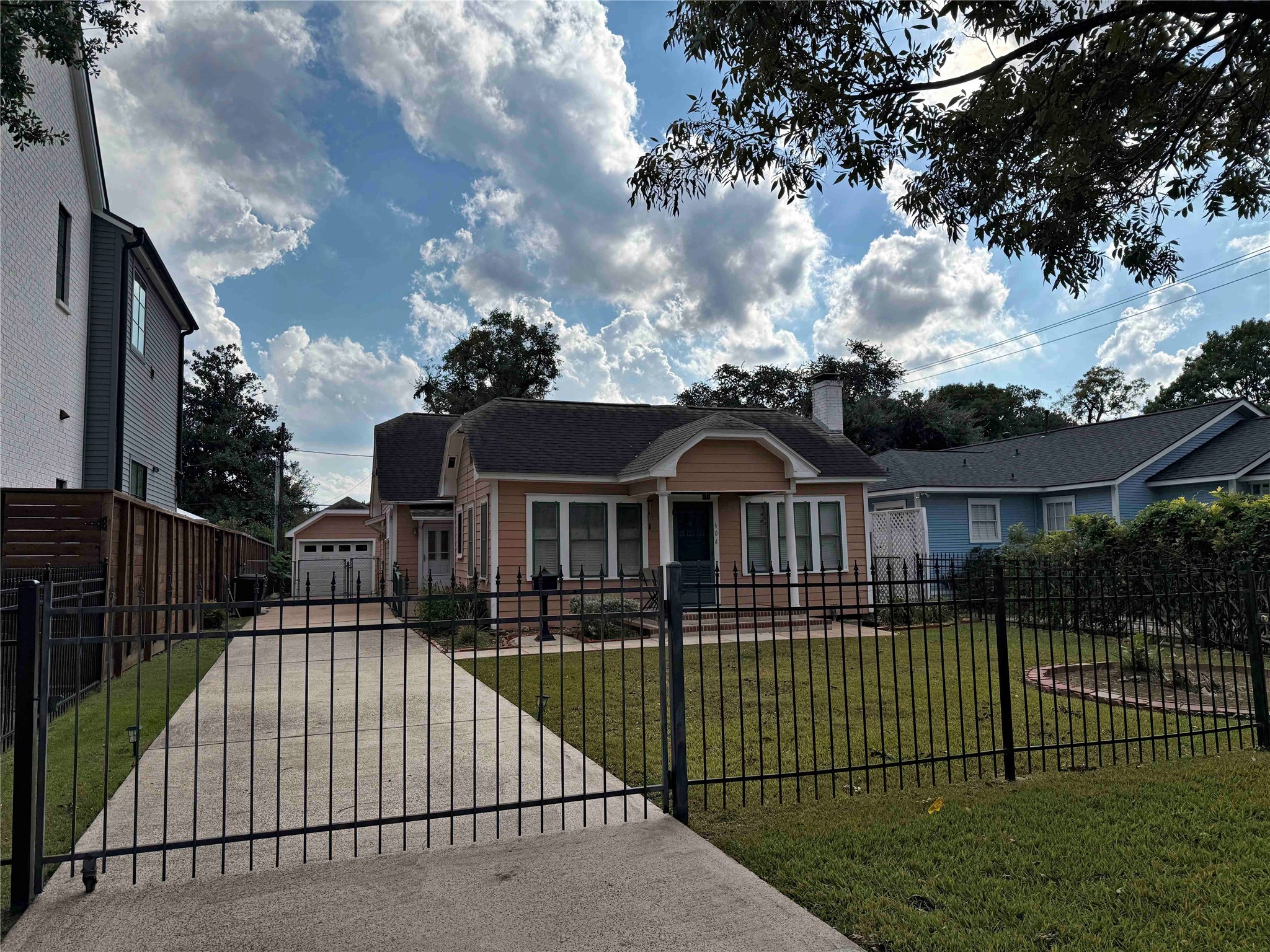 604 East 17th Street Houston, TX 77008 - Photo 24 of 28 a view of a brick house with a small yard plants and large trees