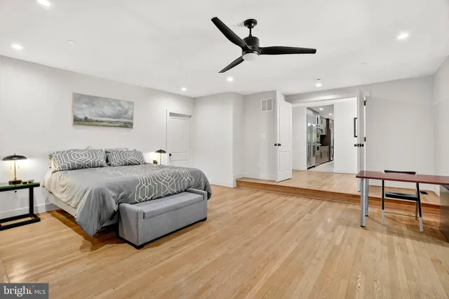 a bedroom with two beds and painting on the wall