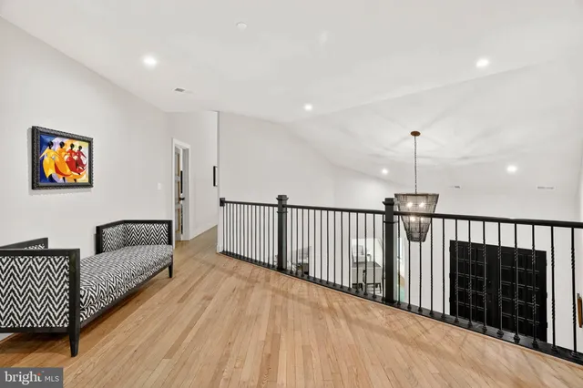 a view of a balcony with chairs and wooden floor