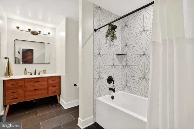 a view of a large yard with plants and a large tree