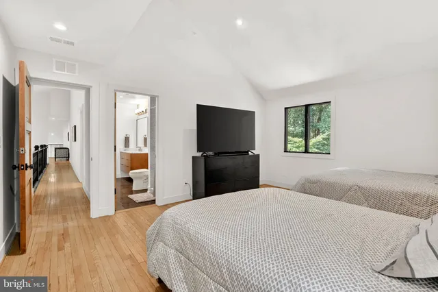 an aerial view of a houses with a yard and lake view