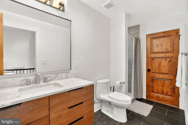 an aerial view of a house with a yard and lake view