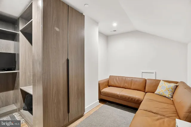 an aerial view of a residential houses with outdoor space and trees all around