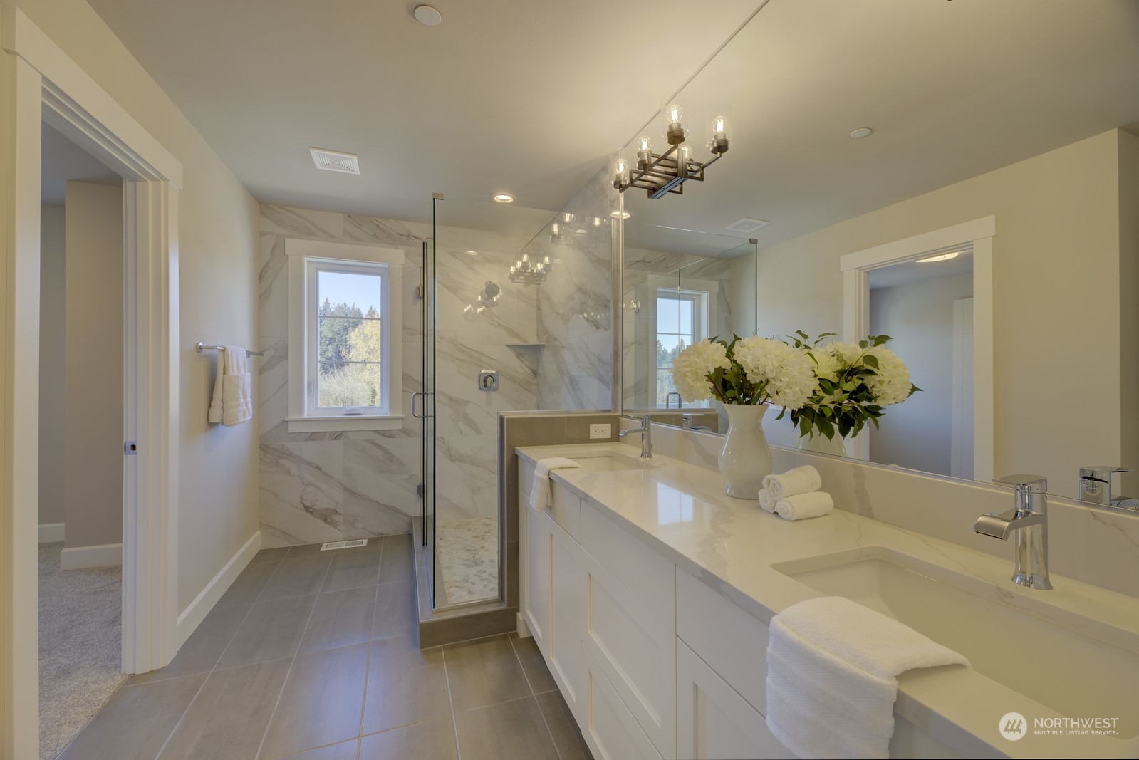20210 94th Drive Northeast Bothell, WA 98011 - Photo 18 of 30 a bathroom with a granite countertop sink a large mirror and a shower