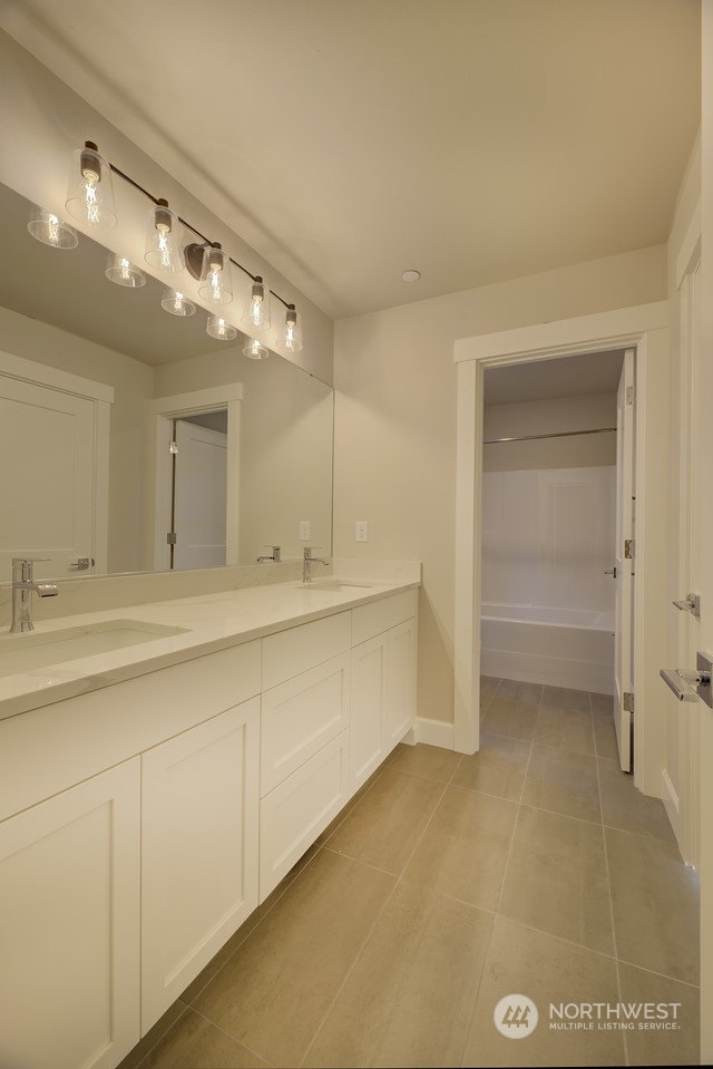 20210 94th Drive Northeast Bothell, WA 98011 - Photo 22 of 30 a bathroom with a double vanity sink and a mirror
