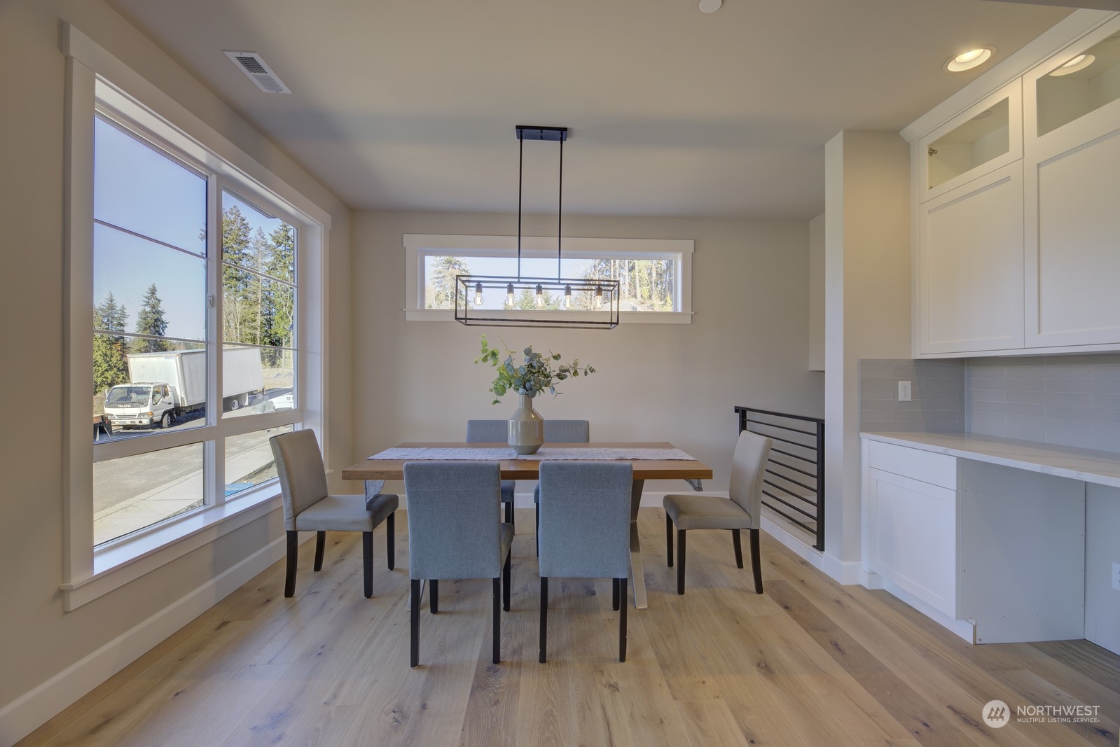 20210 94th Drive Northeast Bothell, WA 98011 - Photo 6 of 30 a dining room with furniture a chandelier and wooden floor