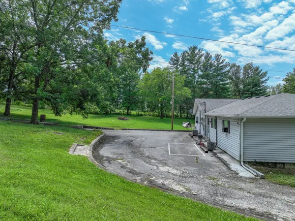 a view of a house with backyard and garden