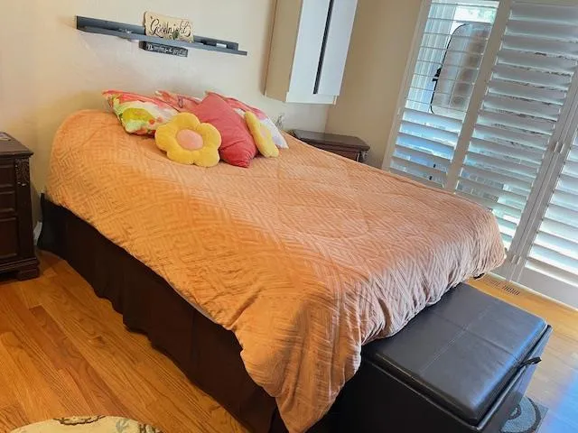 a bedroom with a bed and a window