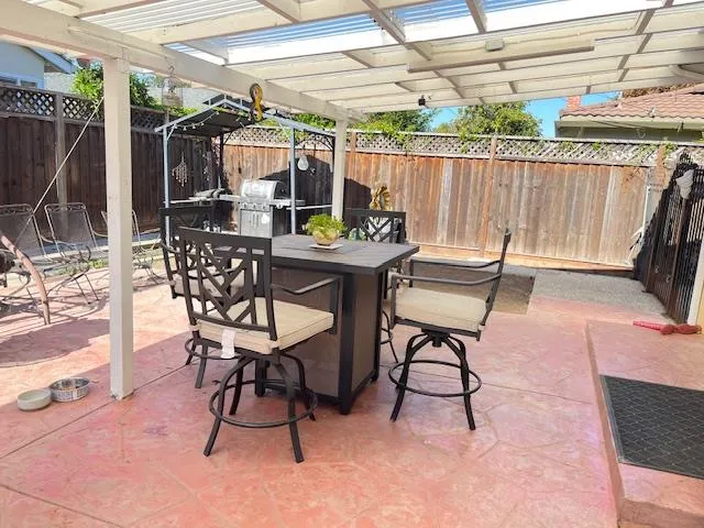a view of a patio with a table and chairs