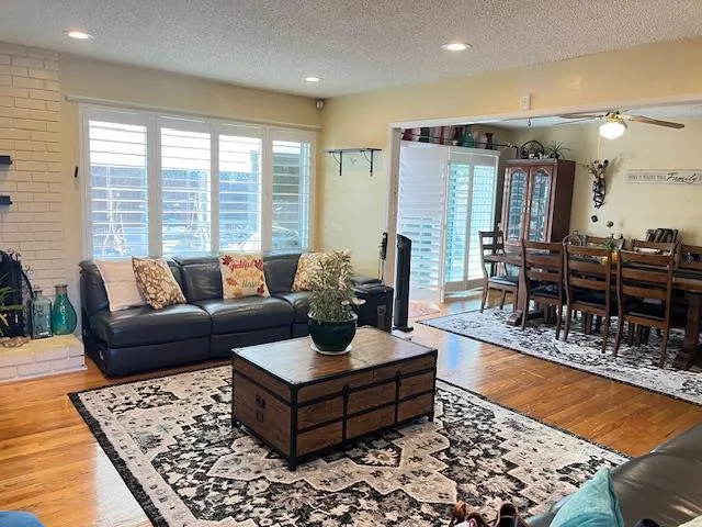 a living room with furniture and wooden floor