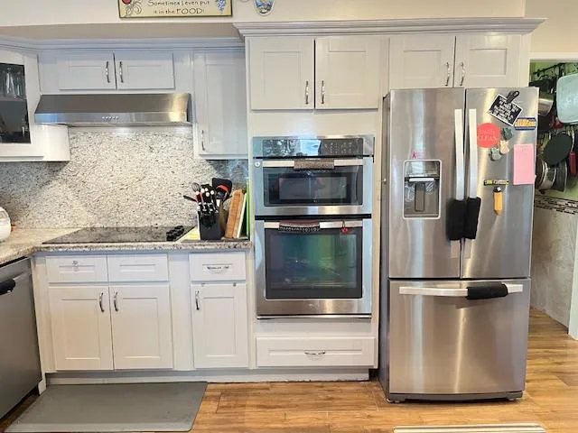 a kitchen with a refrigerator and cabinets