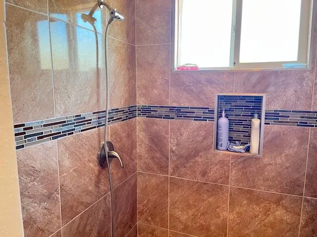 a bathroom with a shower and a mirror