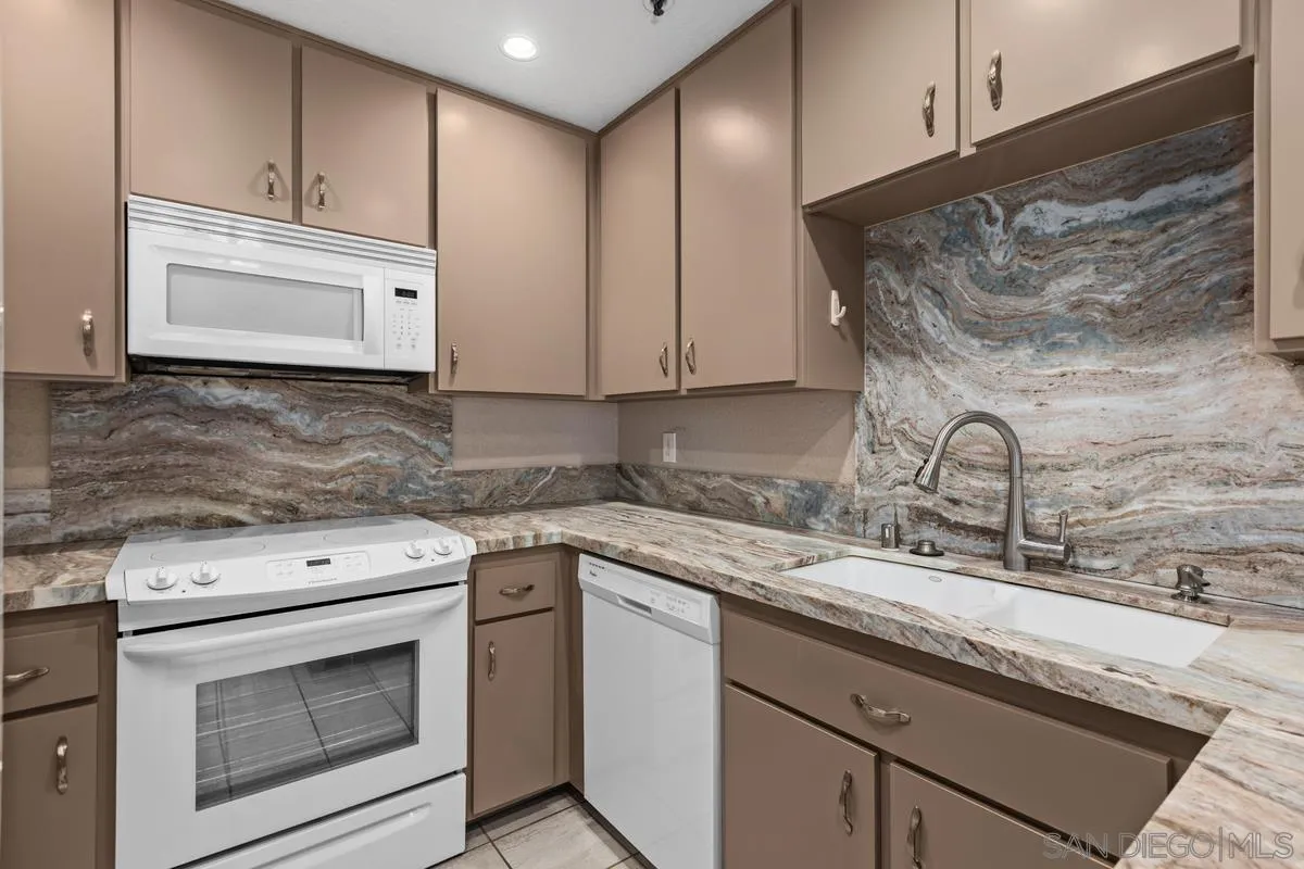 5645 Friars Road, Unit 397 San Diego, CA 92110 - Photo 5 of 22 a kitchen with stainless steel appliances granite countertop a sink stove and cabinets