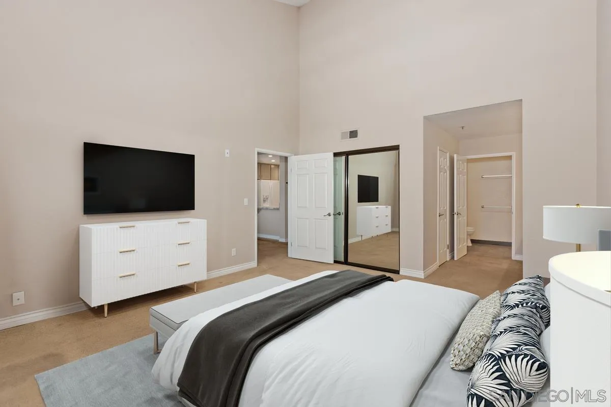 5645 Friars Road, Unit 397 San Diego, CA 92110 - Photo 6 of 22 a bedroom with a bed and a flat screen tv