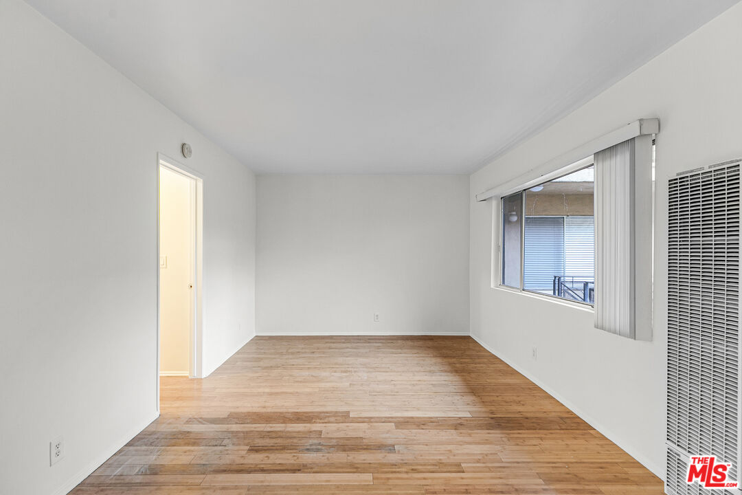 2637 South Centinela Avenue, Unit 13 Santa Monica, CA 90405 - Photo 3 of 15 a view of an empty room with wooden floor and a window