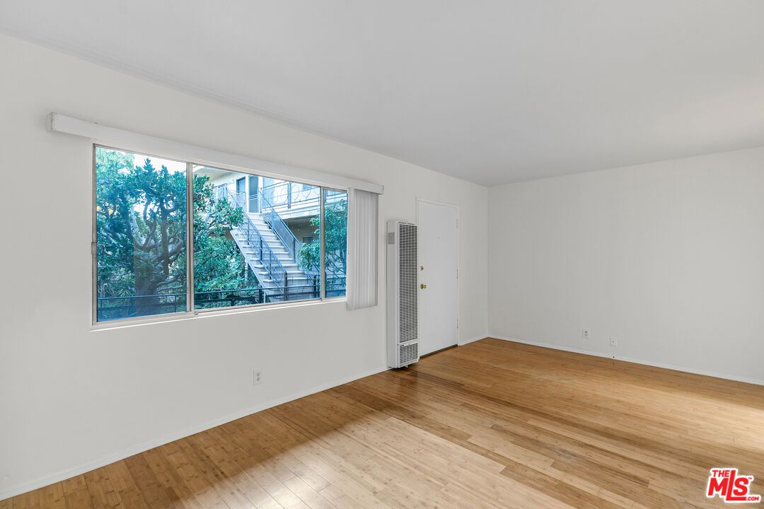 2637 South Centinela Avenue, Unit 13 Santa Monica, CA 90405 - Photo 4 of 15 a view of empty room with wooden floor and fan